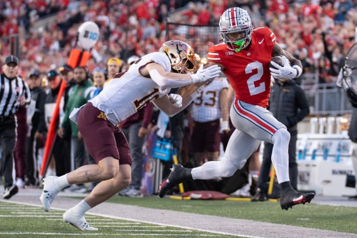 Nov 18, 2023; Columbus, Ohio, USA; Ohio State Buckeyes wide receiver Emeka Egbuka (2) is run out of bounds by Minnesota Golden Gophers defensive back Coleman Bryson (16) during the first half of their game on Saturday, Nov. 18, 2023 at Ohio Stadium.